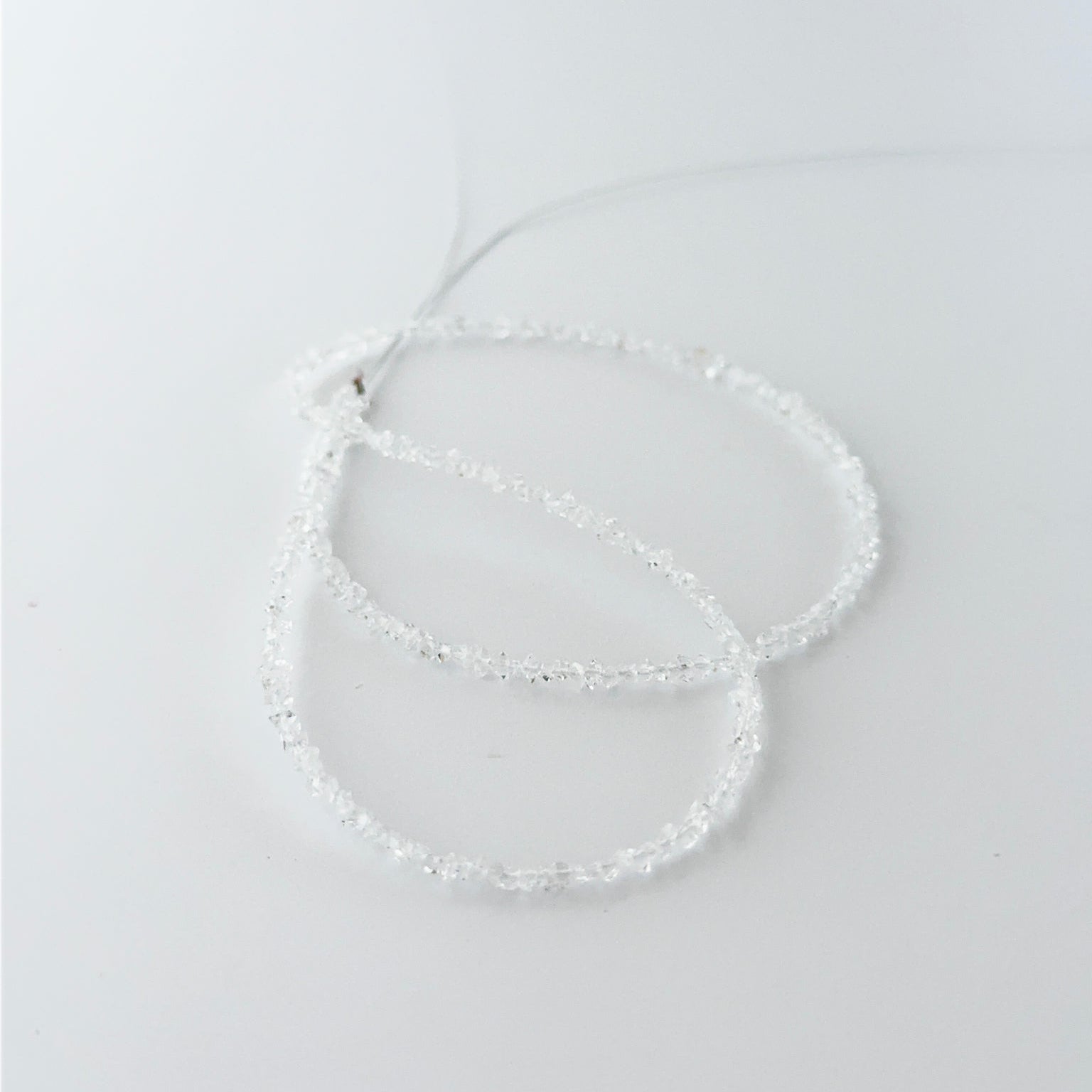 Small Herkimer Diamond chips arranged neatly, highlighting their raw finish and handmade jewellery component quality
