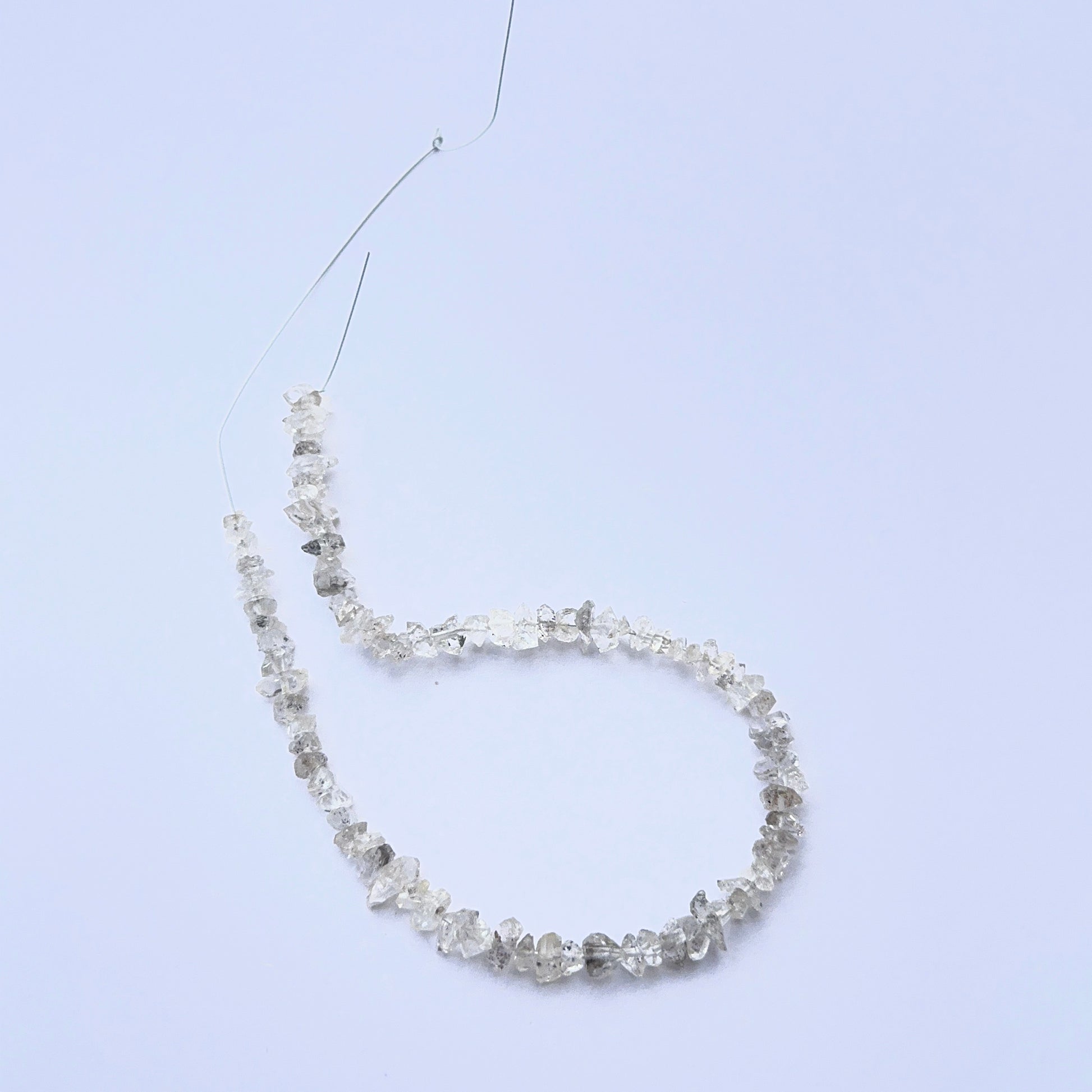 Raw Herkimer Diamond beads displayed with visible crystalline structure ideal for jewellery making.