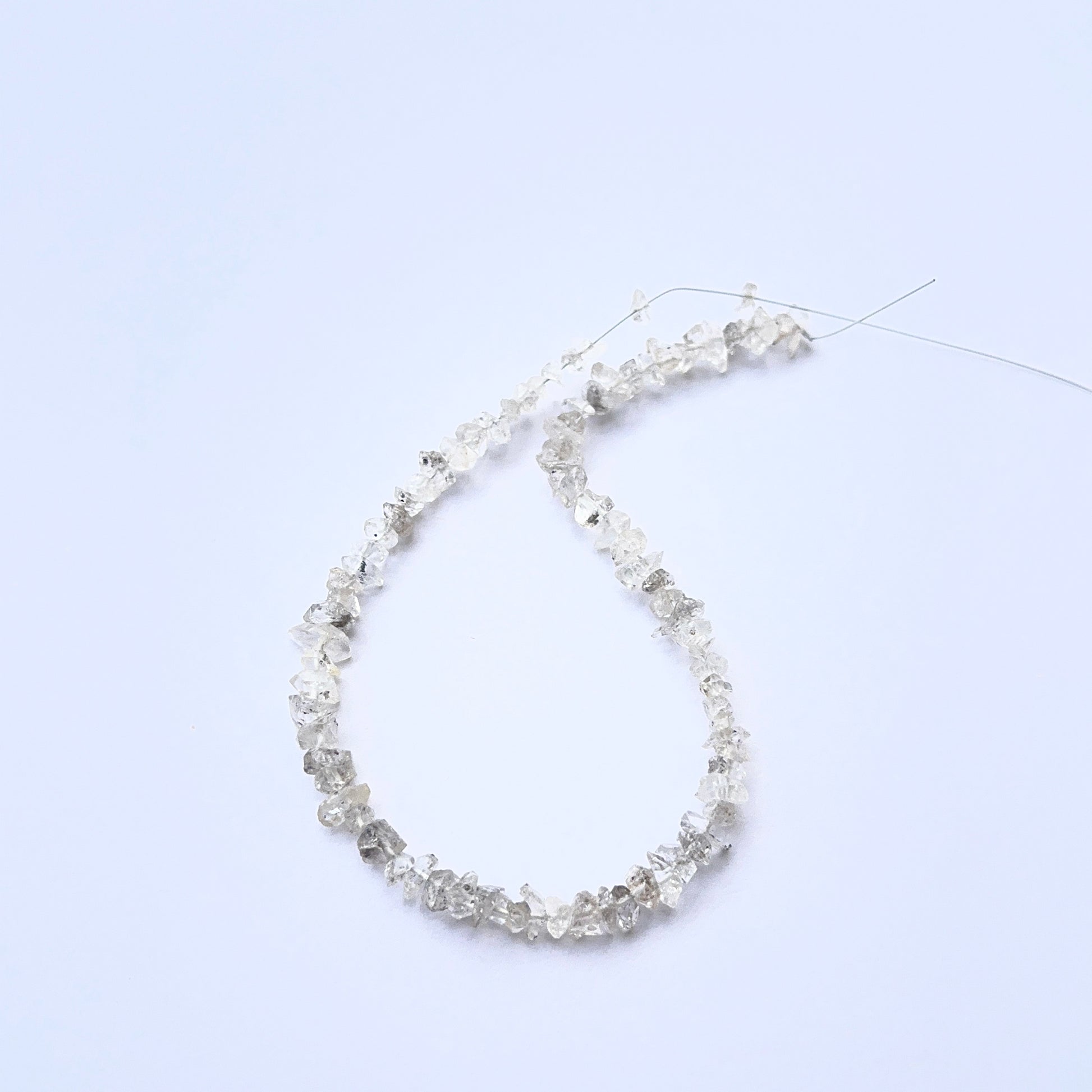 Herkimer Diamond rough beads photographed to show their unpolished finish and sparkle.