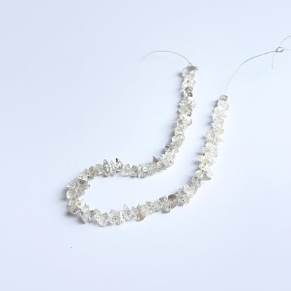 Close‑up of Herkimer Diamond rough beads highlighting their bright shine and organic crystal texture.