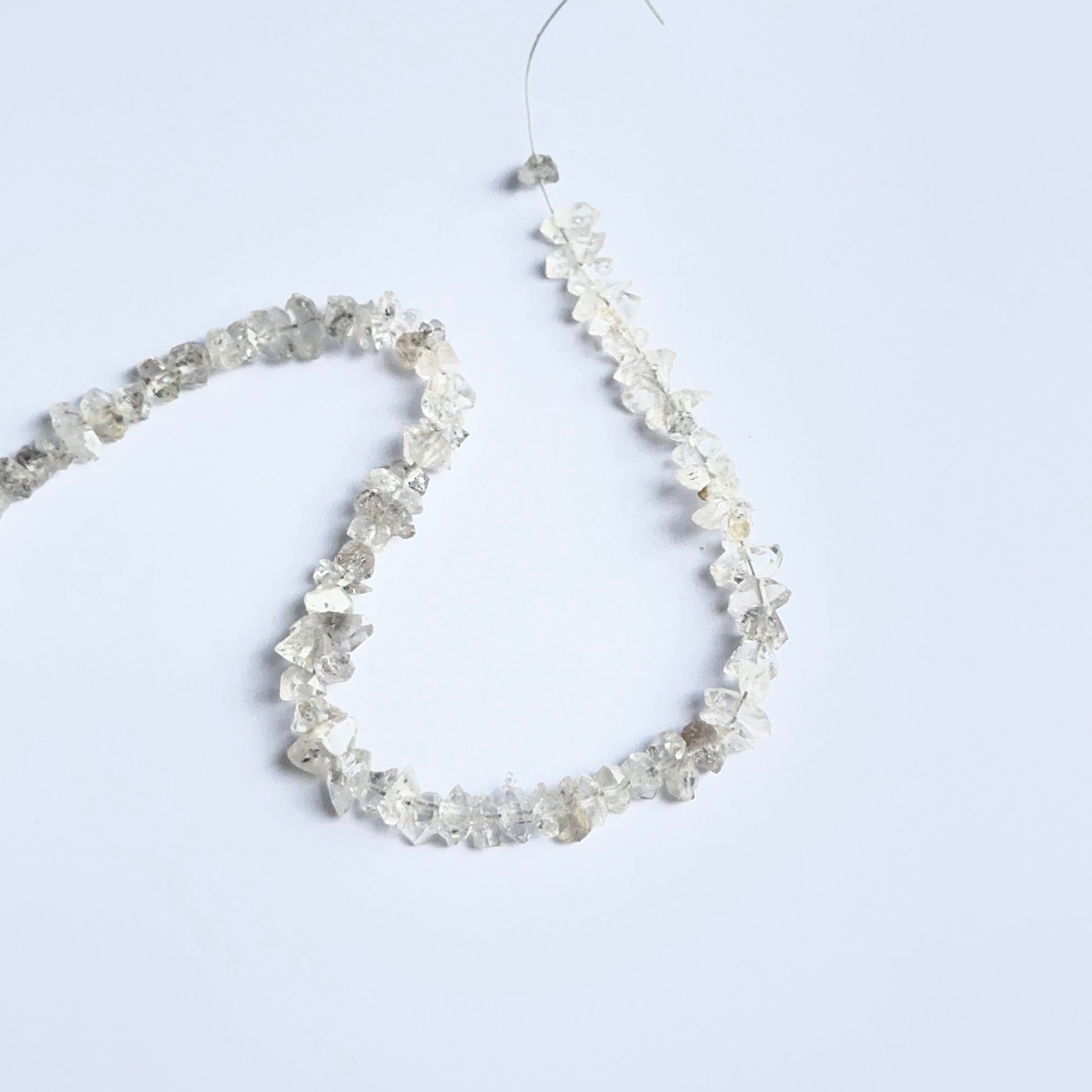 Herkimer Diamond rough stones arranged neatly to showcase natural gemstone quality and brilliance.