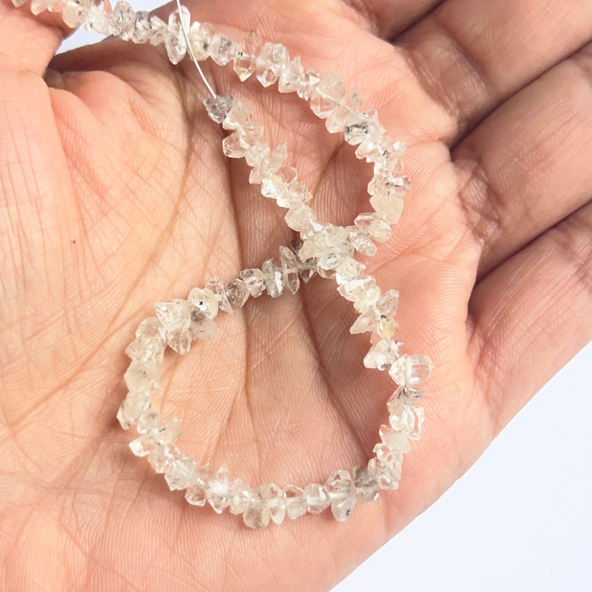 Raw Herkimer Diamond beads displayed with visible crystalline structure ideal for jewellery making.