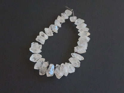 Natural gemstone beads for DIY jewellery showcasing drilled Herkimer Diamond in rough cut. 