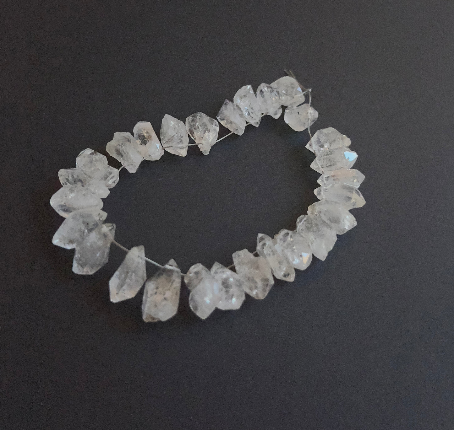 Detailed view of 6–7mm drilled Herkimer Diamond beads with bright crystal shine.