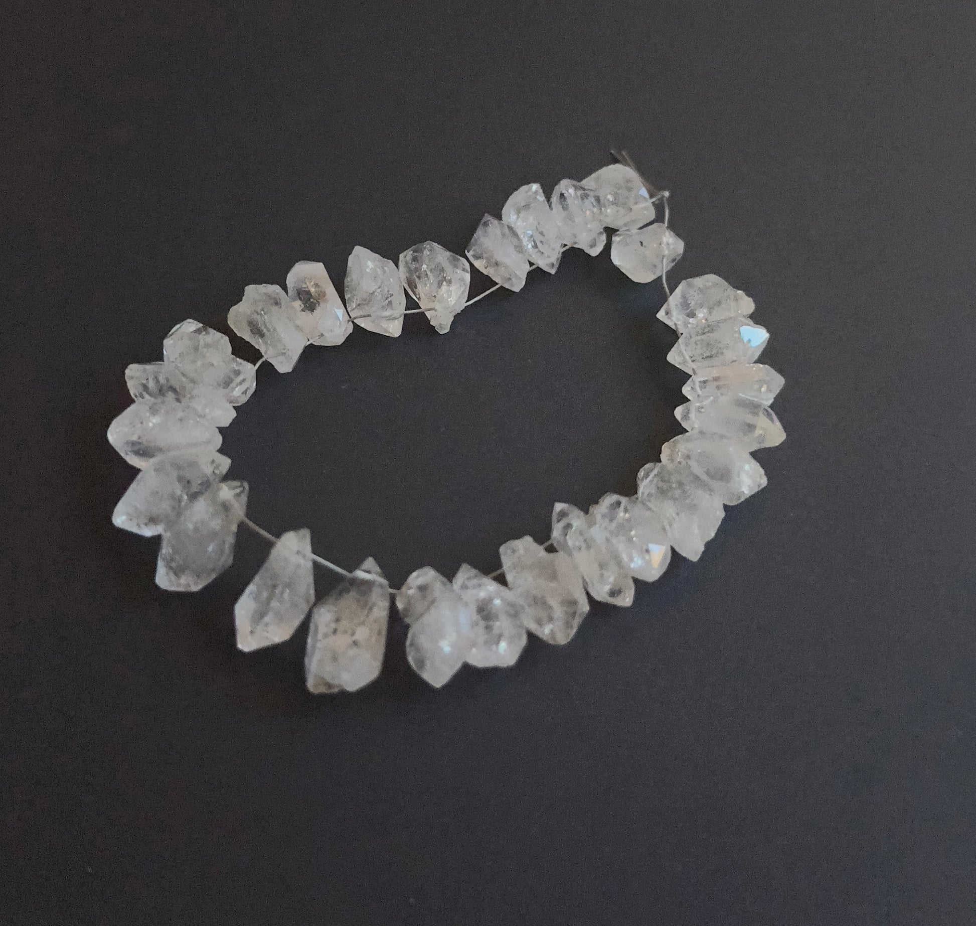 Detailed view of 6–7mm drilled Herkimer Diamond beads with bright crystal shine.