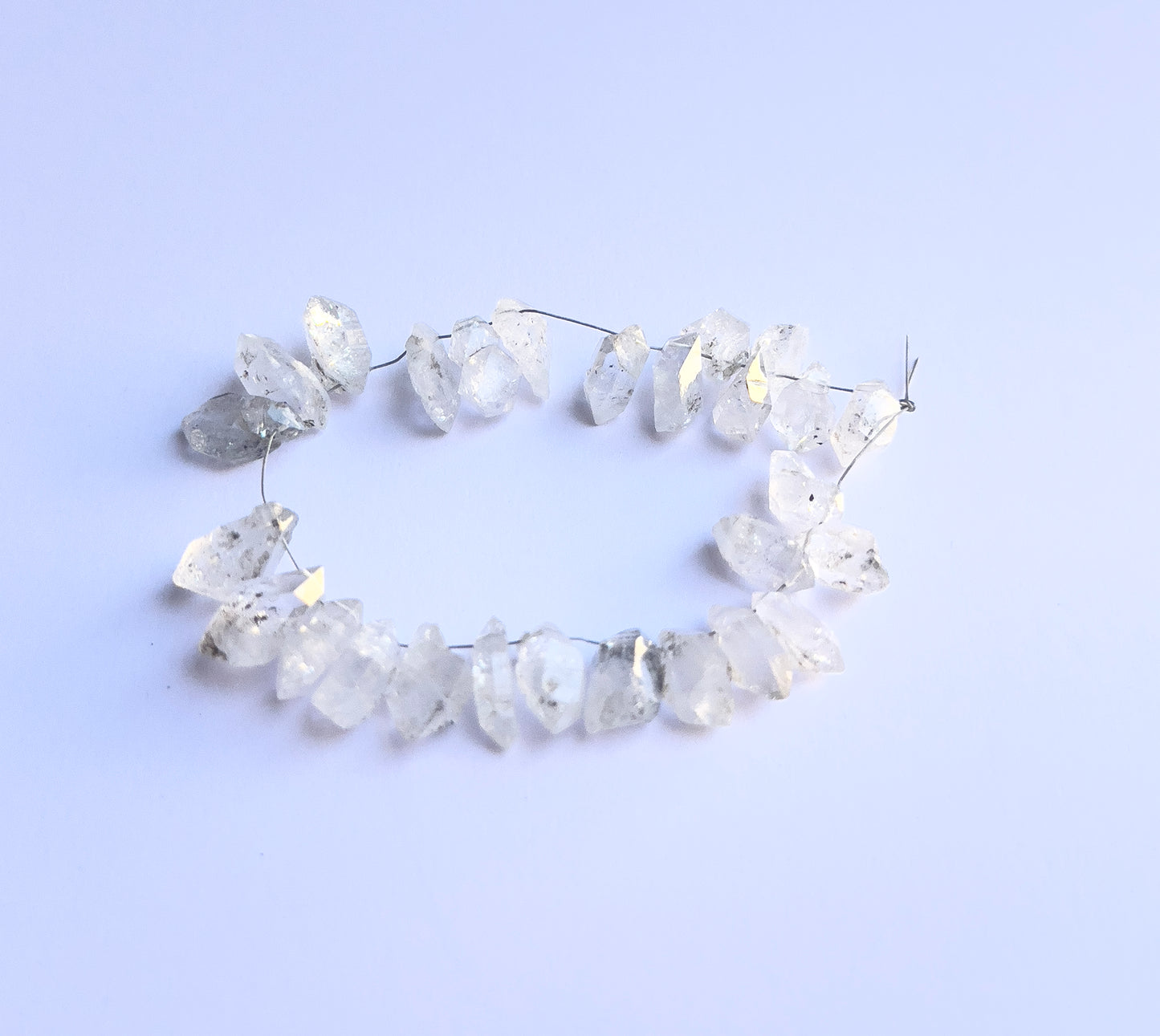 Stone beads with natural facets and drilled holes, perfect for custom jewellery designs. 