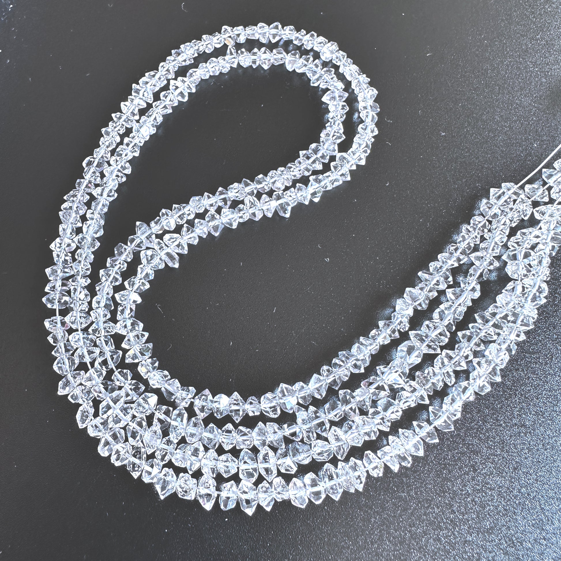 Herkimer Diamond rough beads with centre drill, arranged on a 20cm strand with natural clarity and sparkle.