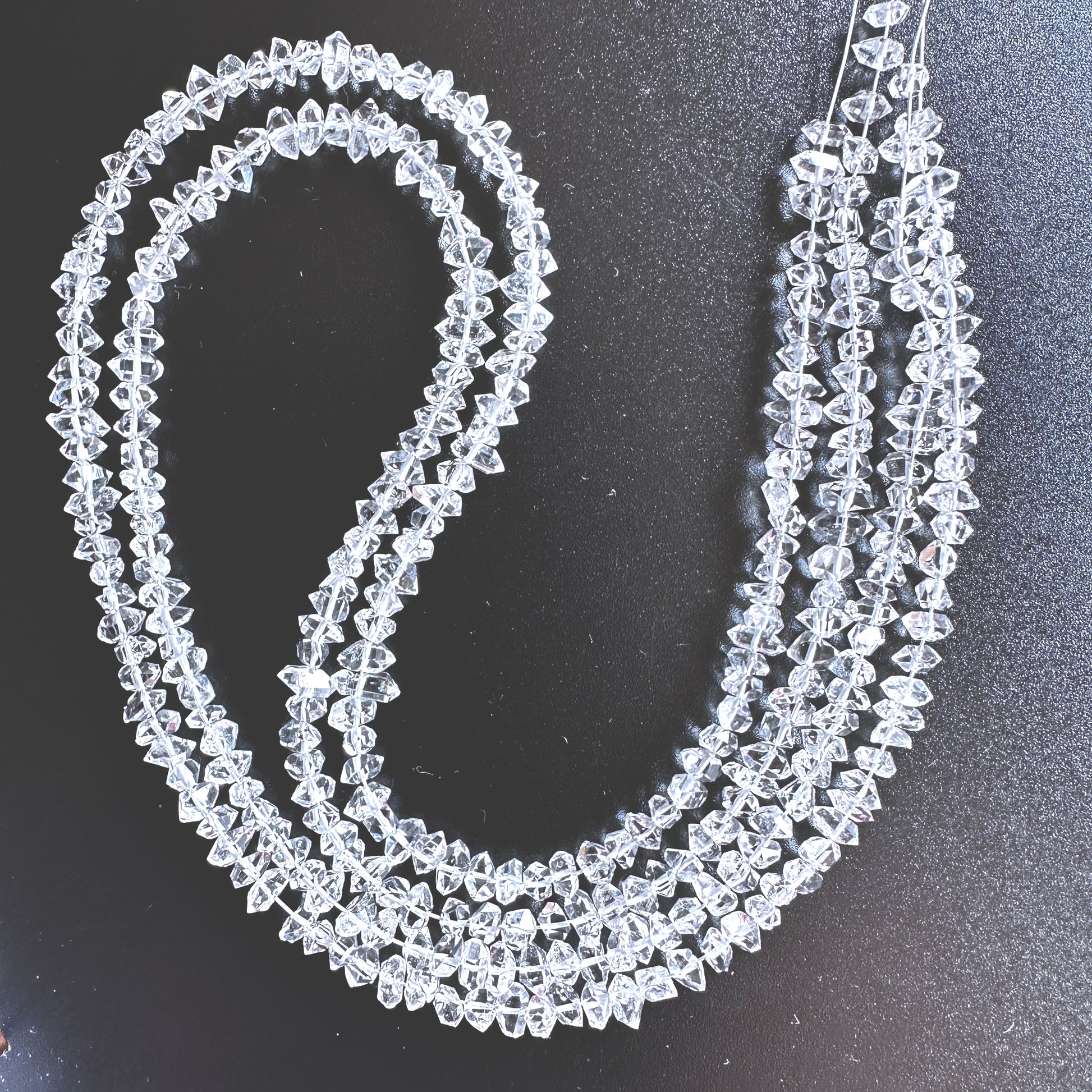 Close-up of 3.5-5mm Herkimer Diamond stone beads showing raw texture and organic faceting.