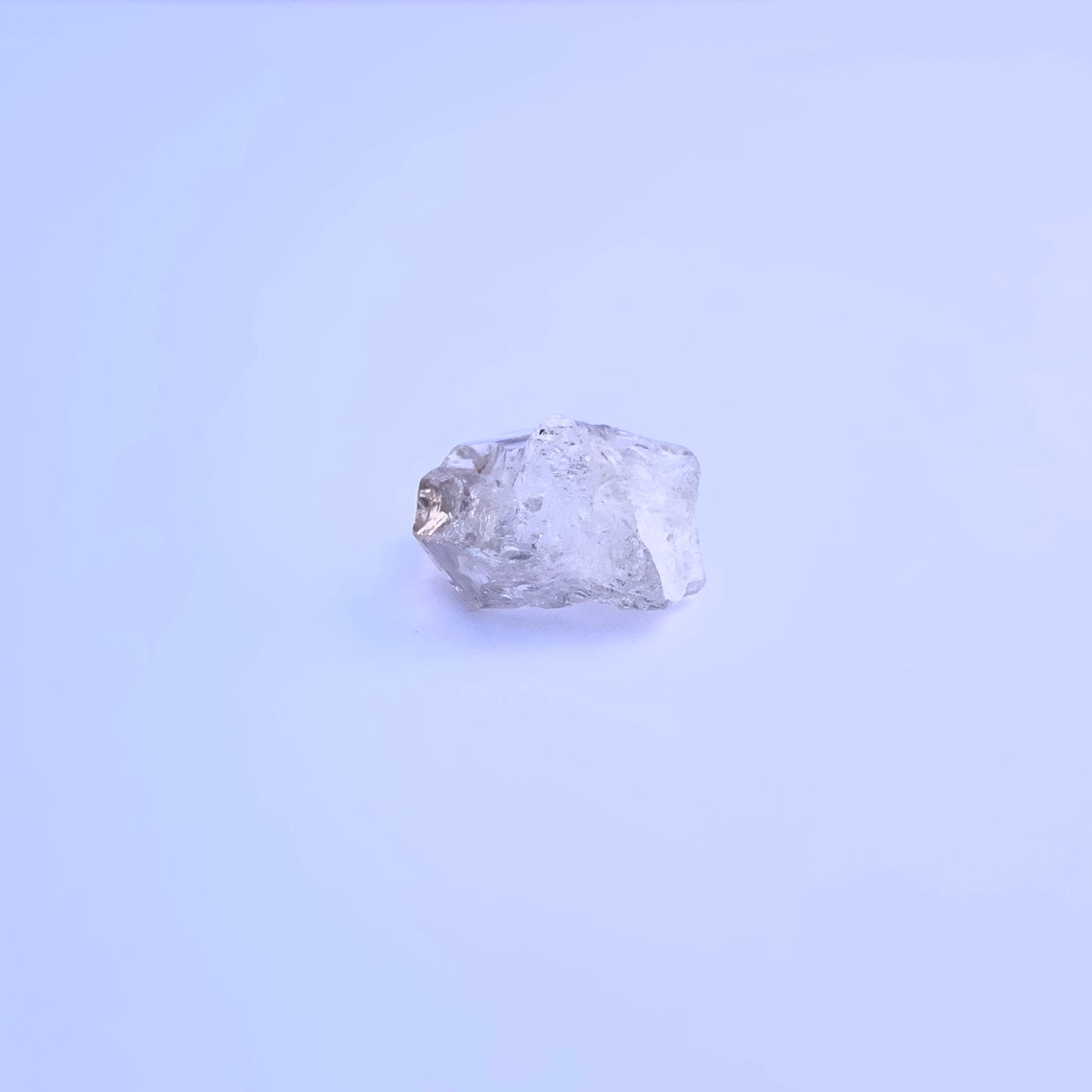 Natural Herkimer Diamond stone with uncut facets and earthy character.