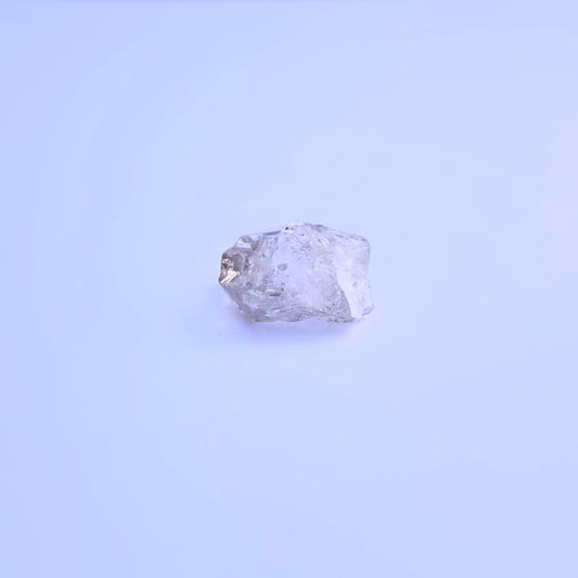 Natural Herkimer Diamond stone with uncut facets and earthy character.