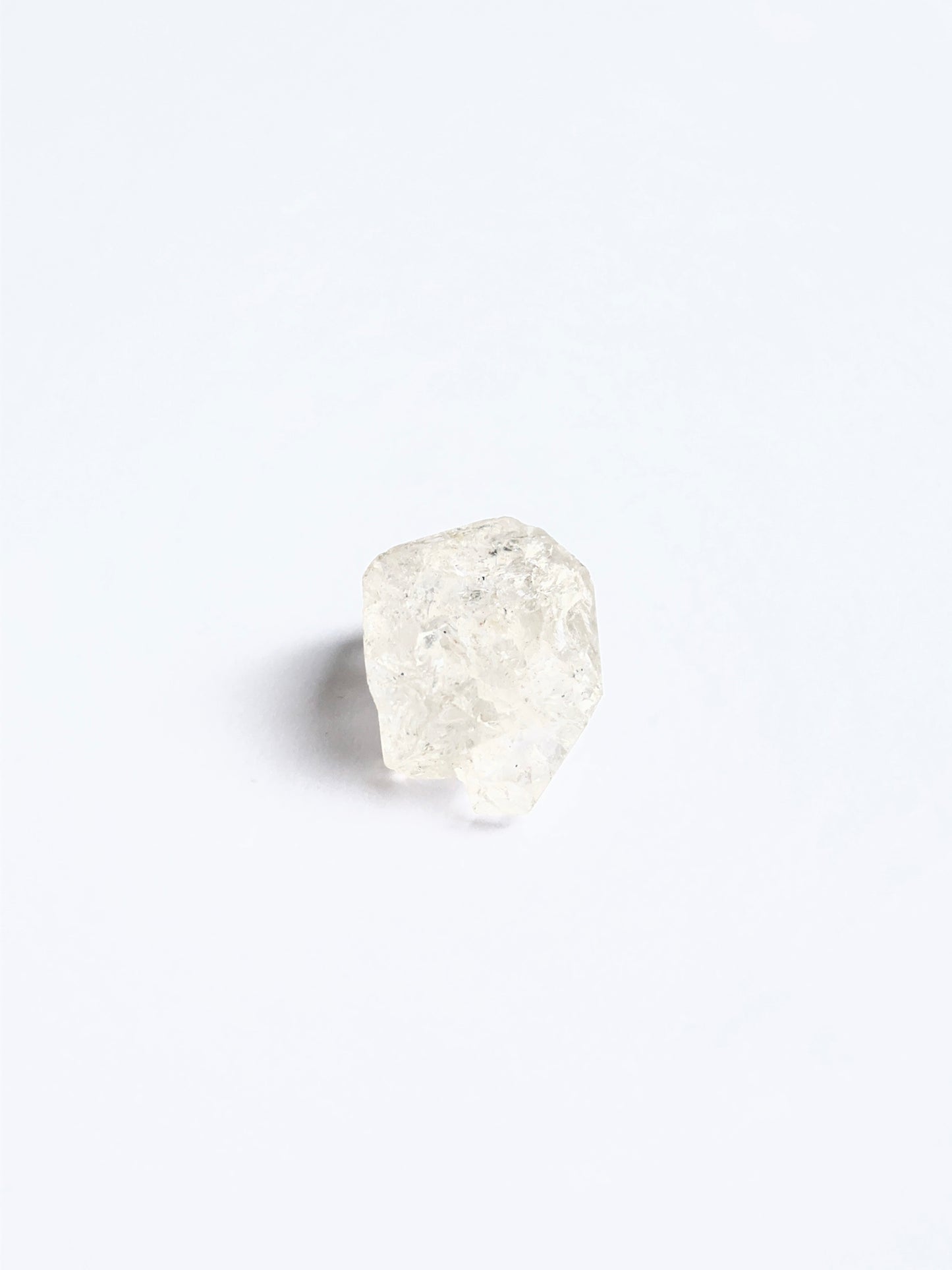 Large Herkimer Diamond rough piece arranged on a white background showcasing its brilliance.