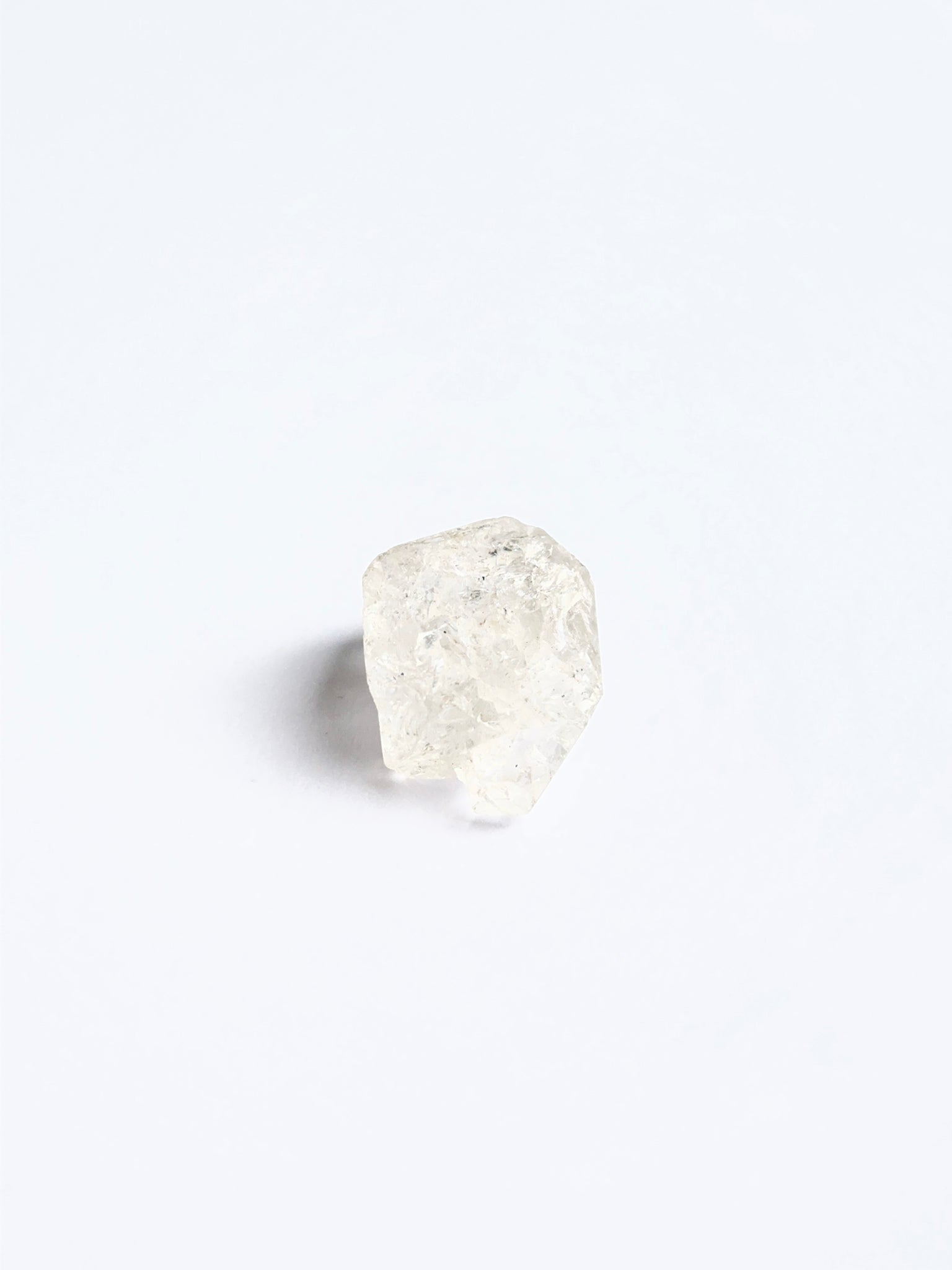 Large Herkimer Diamond rough piece arranged on a white background showcasing its brilliance.