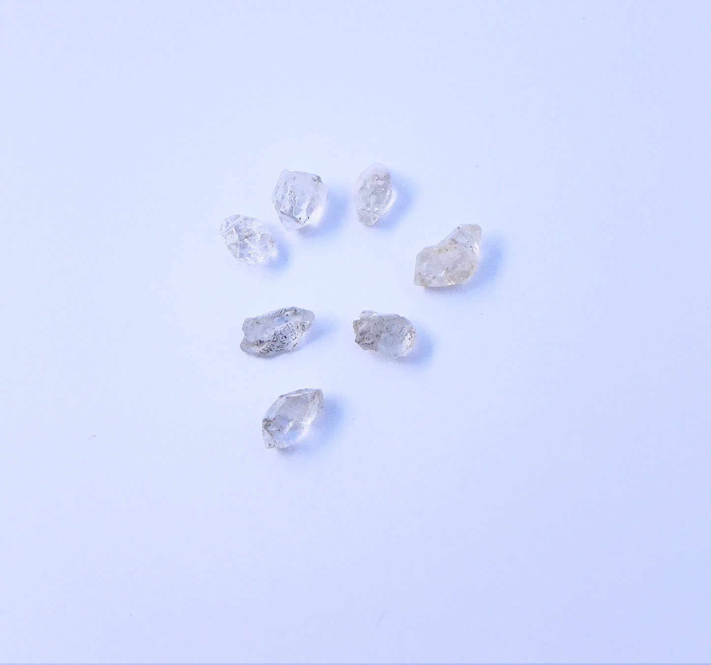 Close-up of 7 Herkimer Diamond stone beads featuring raw crystal texture and organic shapes. 