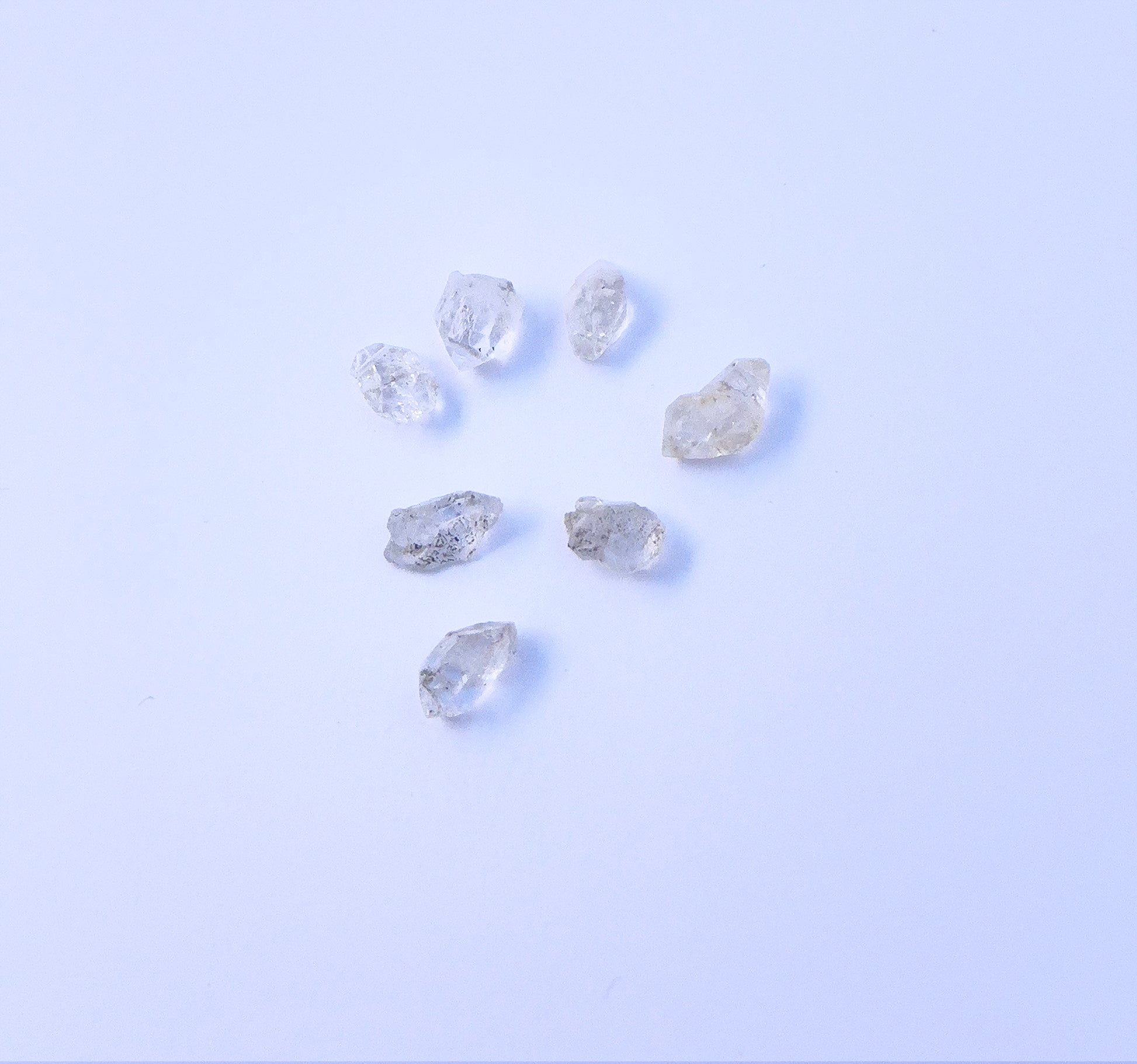 Close-up of 7 Herkimer Diamond stone beads featuring raw crystal texture and organic shapes. 