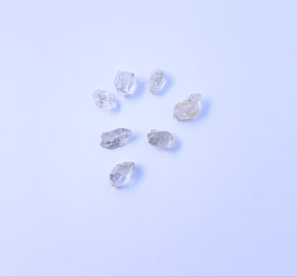 Close-up of 7 Herkimer Diamond stone beads featuring raw crystal texture and organic shapes. 
