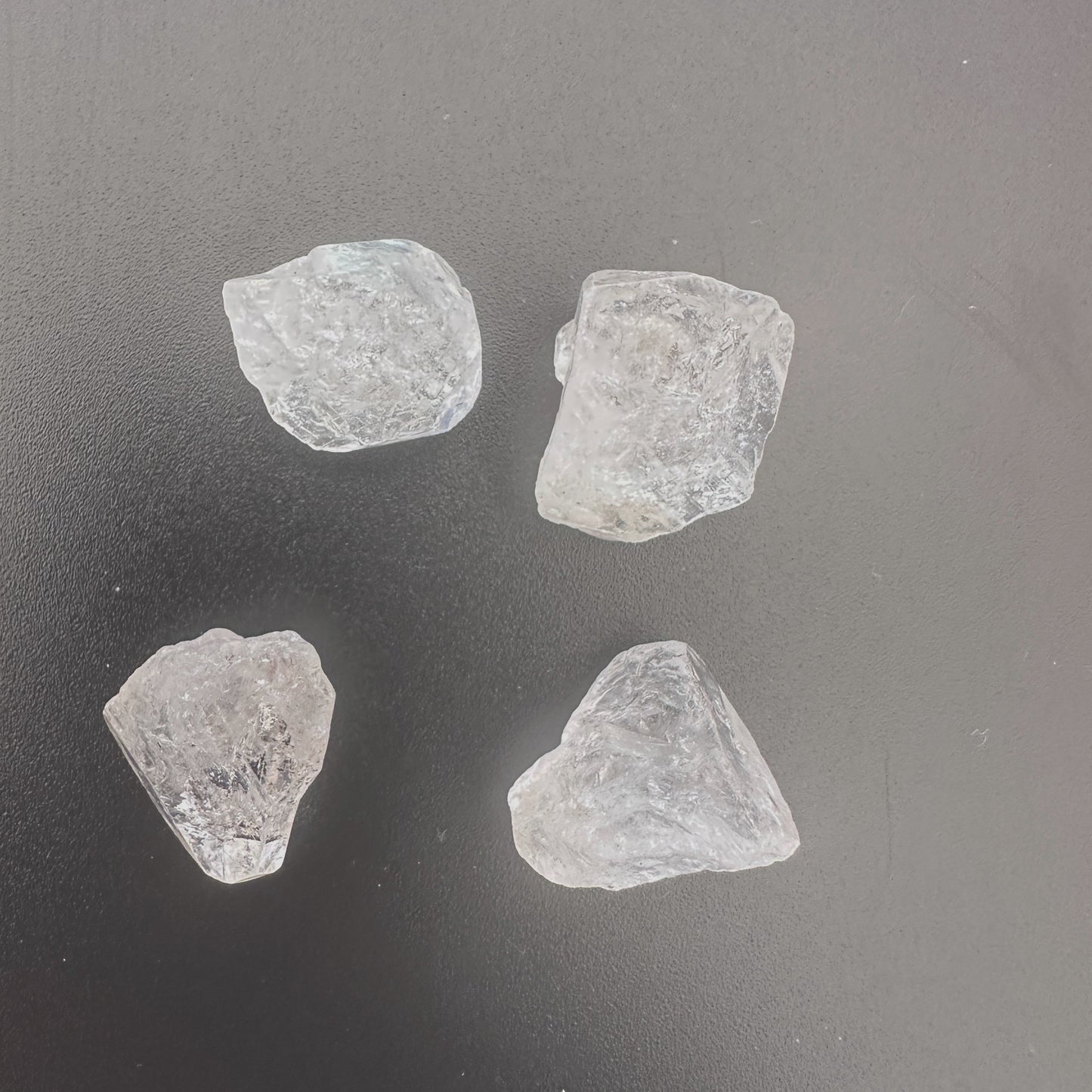 Four large Herkimer Diamonds arranged to showcase their natural shine and crystal structure.