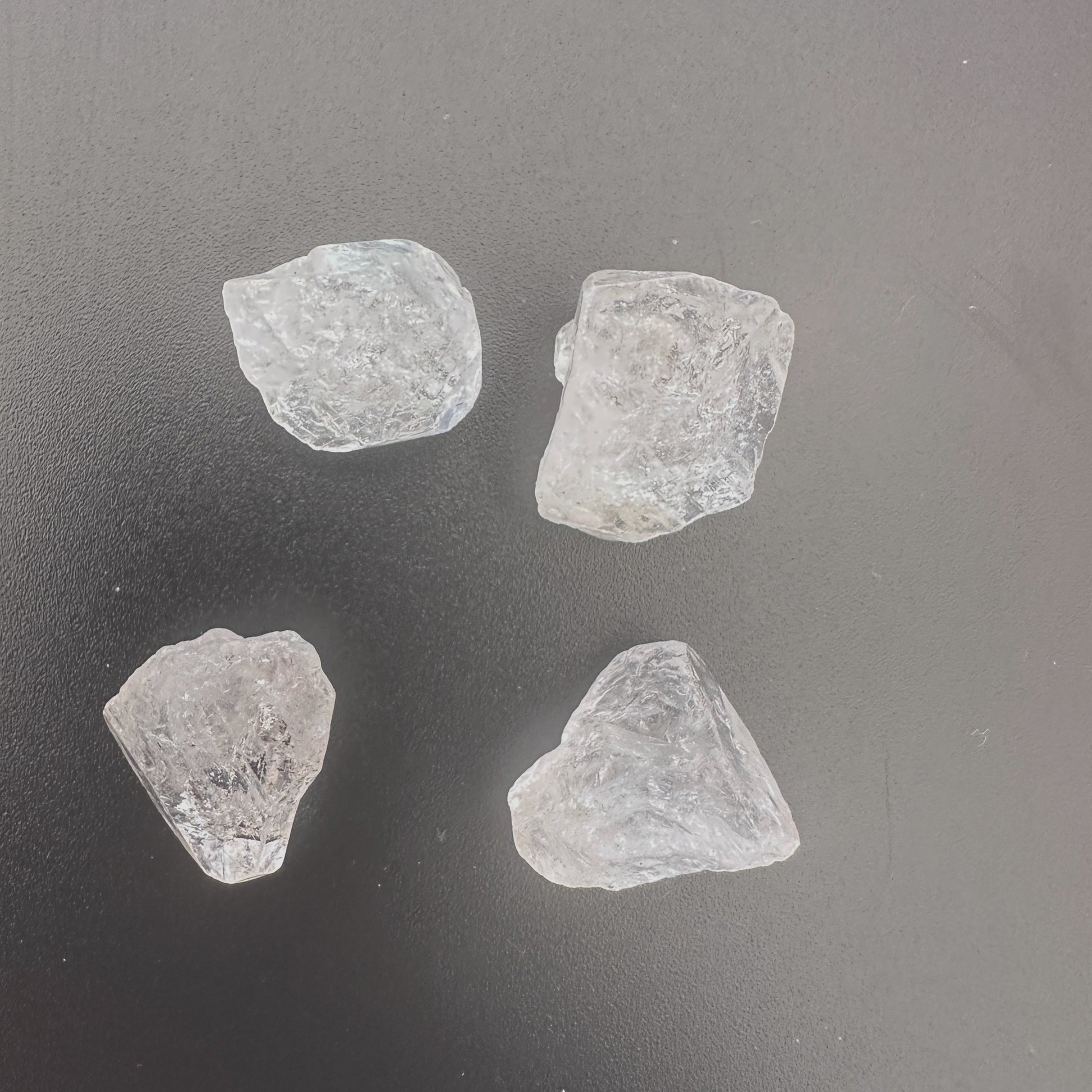 Four large Herkimer Diamonds arranged to showcase their natural shine and crystal structure.