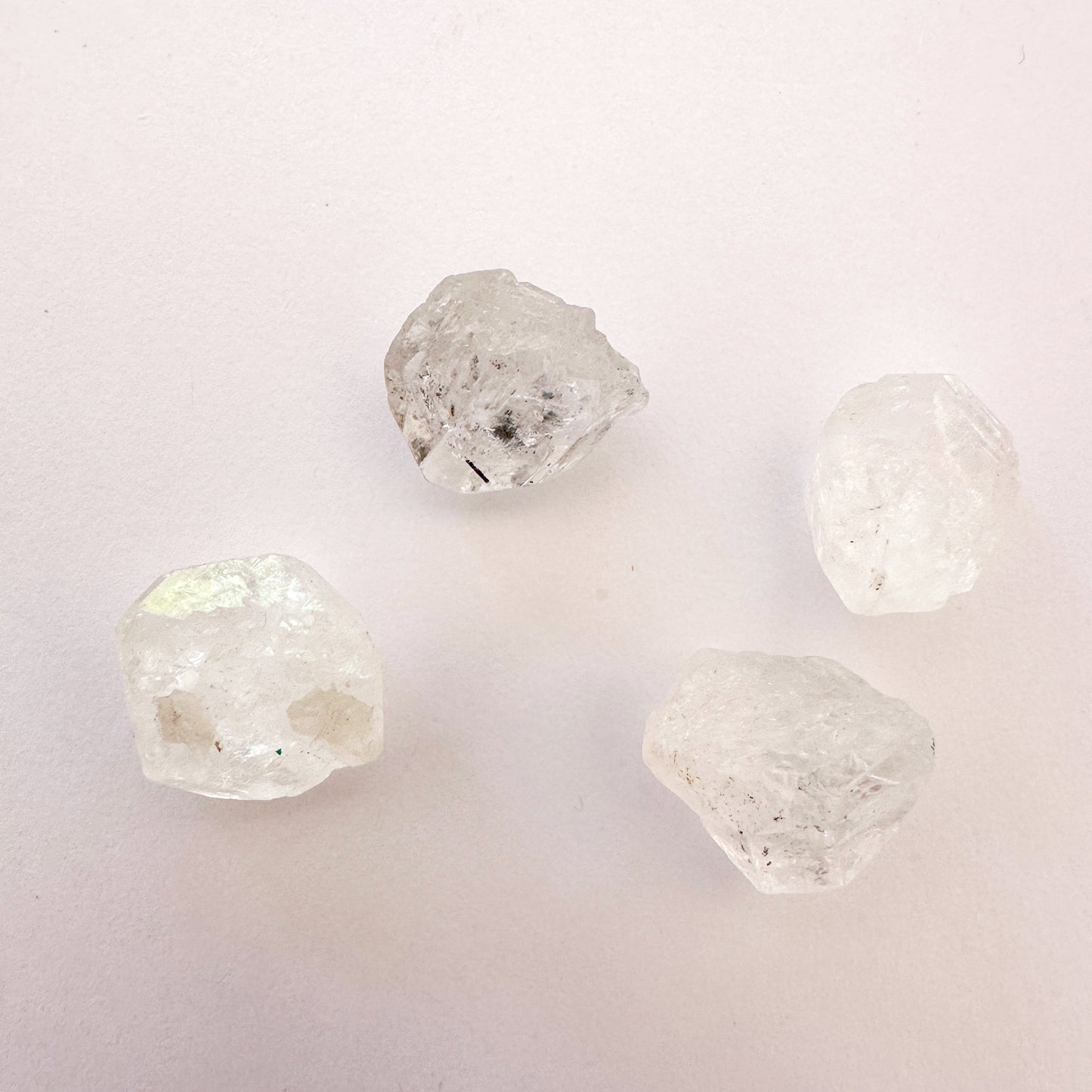 Close-up of Herkimer diamond gemstone highlighting their icy transparency and rugged edges.