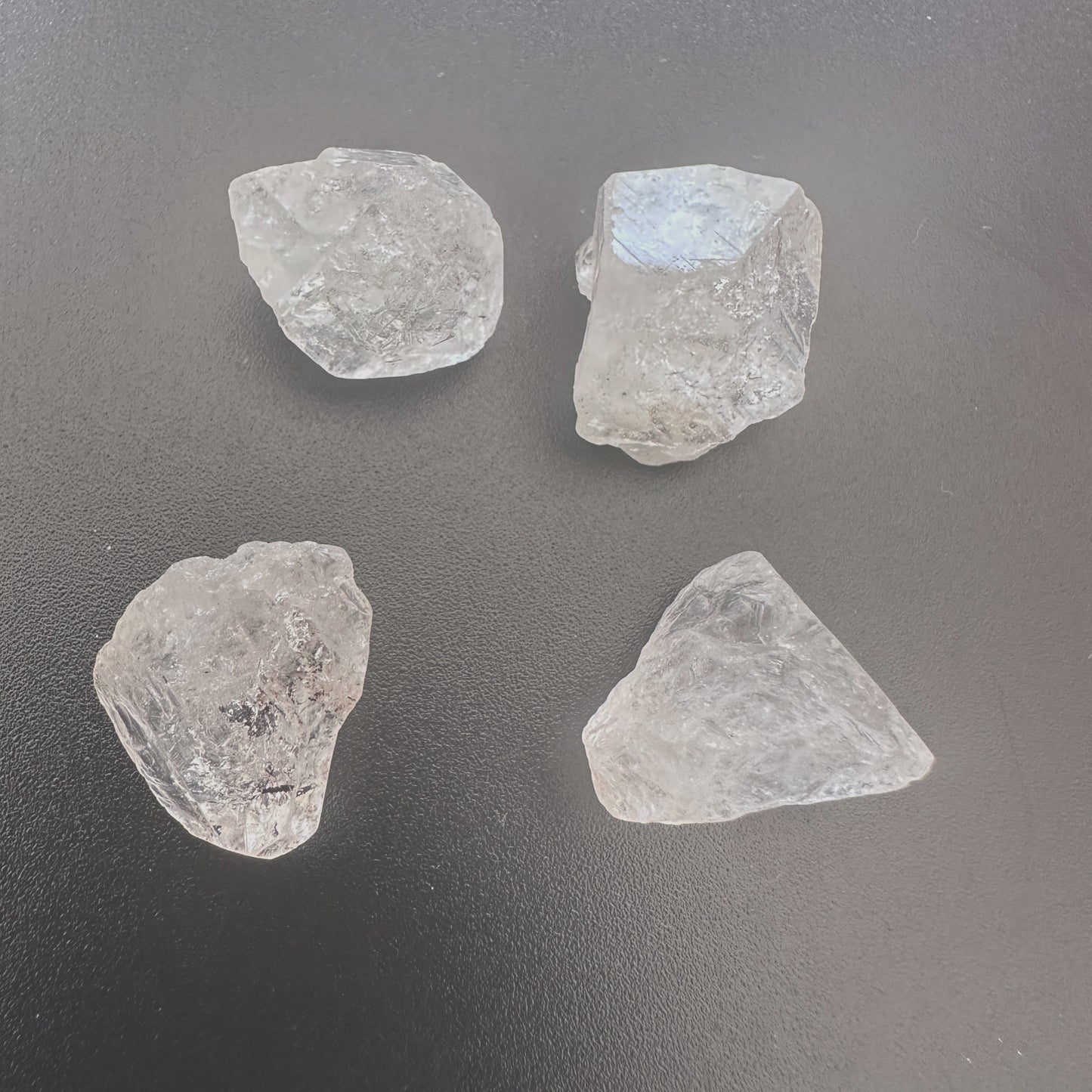 Undrilled Herkimer diamond nuggets with raw clarity and 14–16mm size displayed on a neutral background.