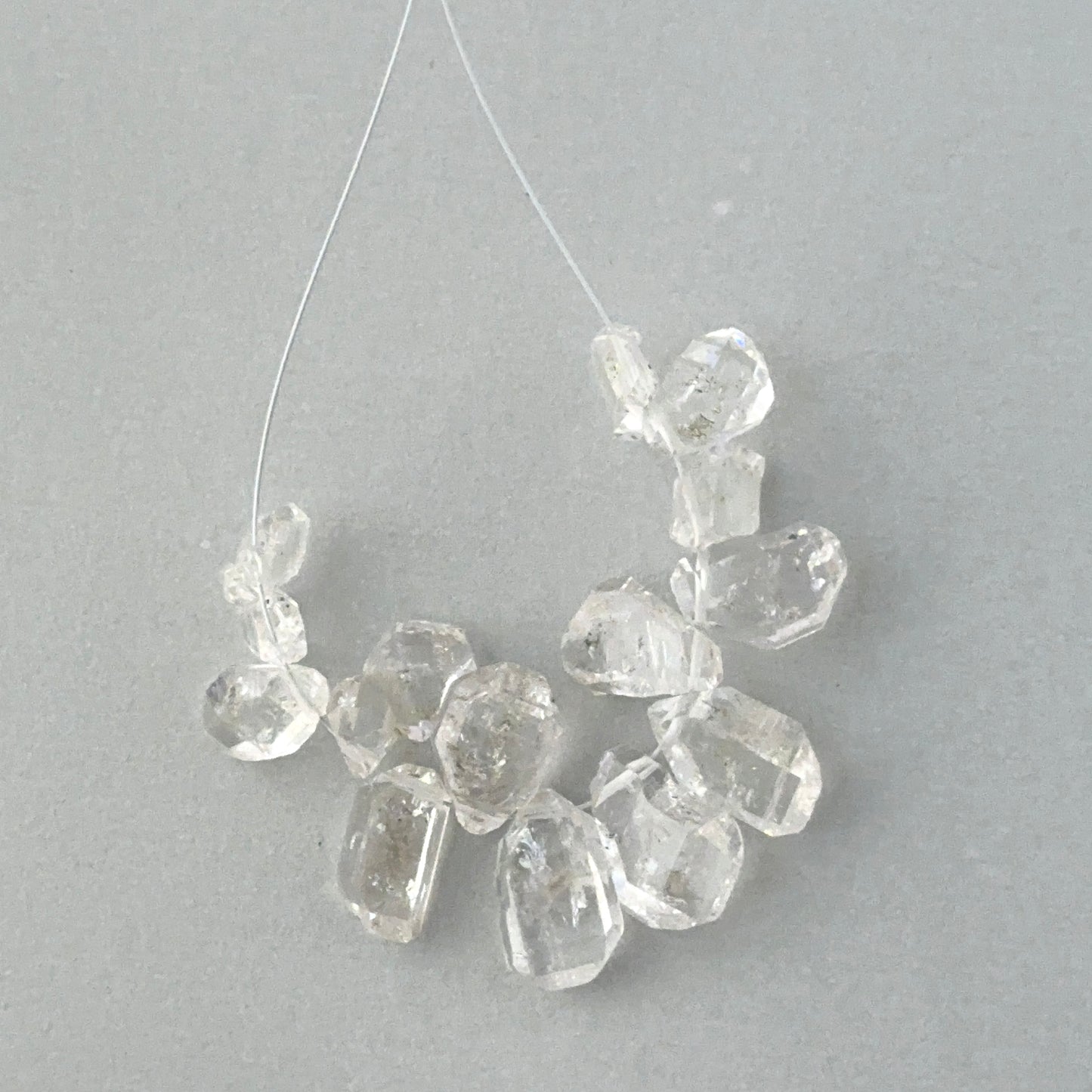 Natural gemstone beads for handmade jewellery components showing organic shapes and water-clear transparency