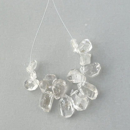 Natural gemstone beads for handmade jewellery components showing organic shapes and water-clear transparency