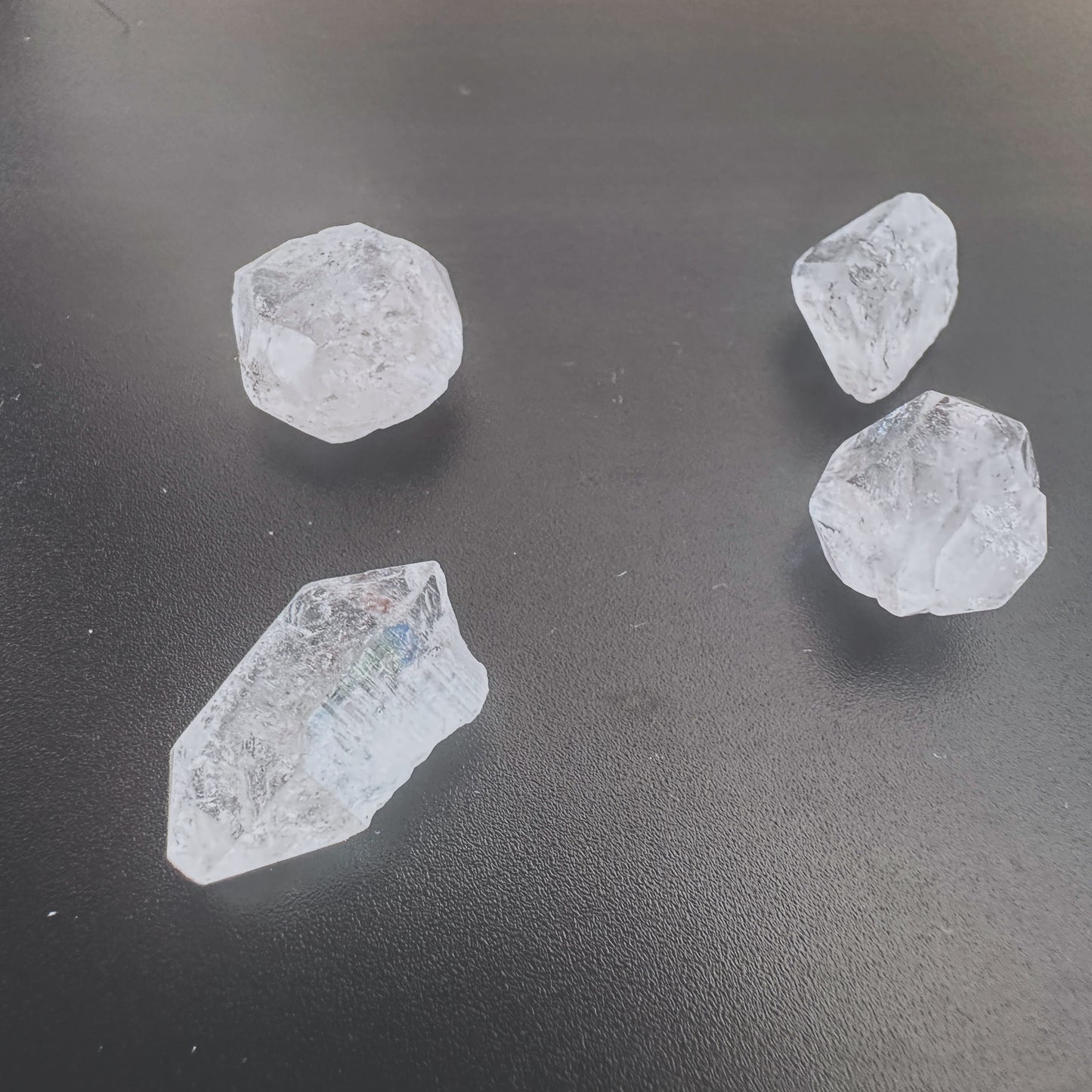 Close-up of Herkimer diamond gemstone showing rugged texture and translucent shine.