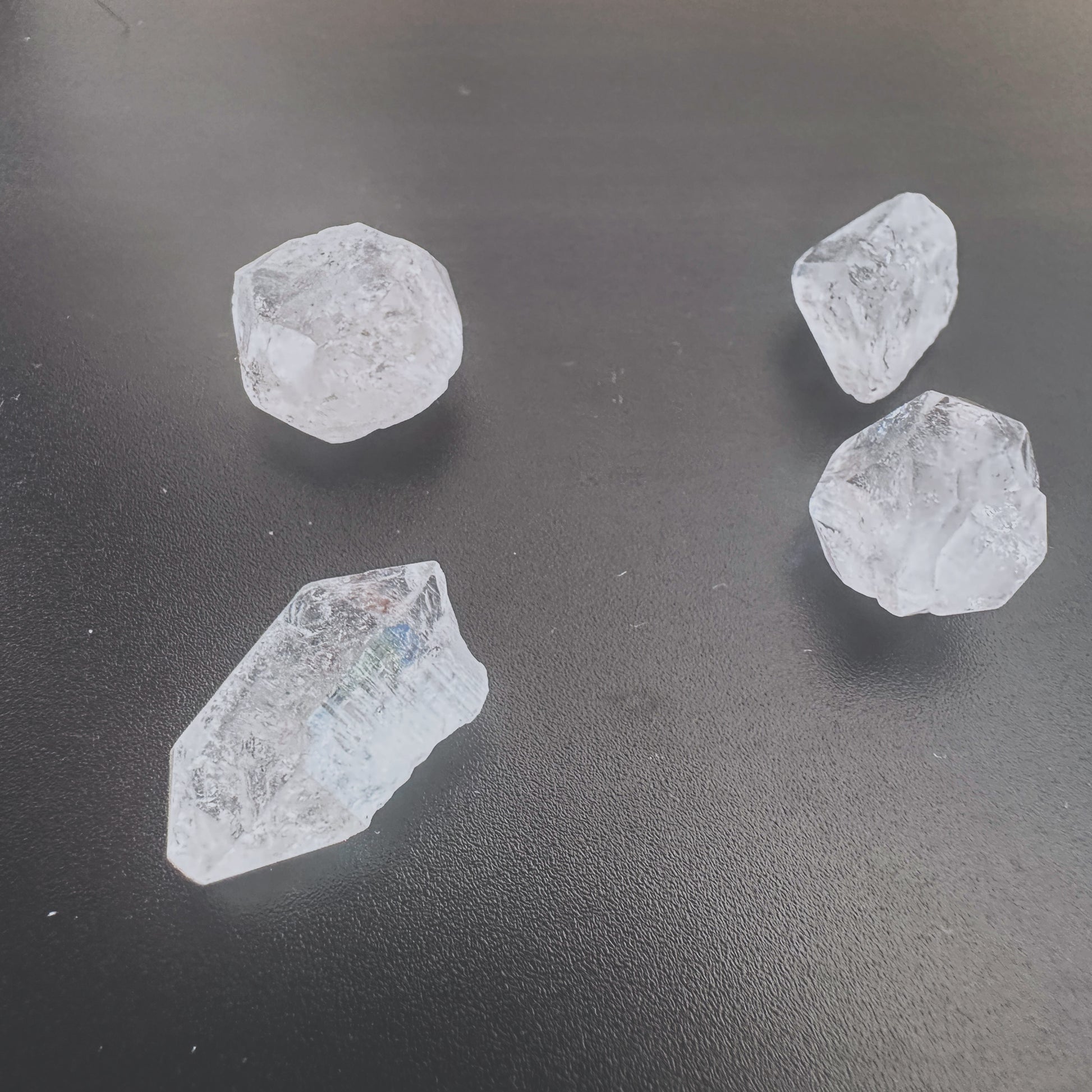 Close-up of Herkimer diamond gemstone showing rugged texture and translucent shine.