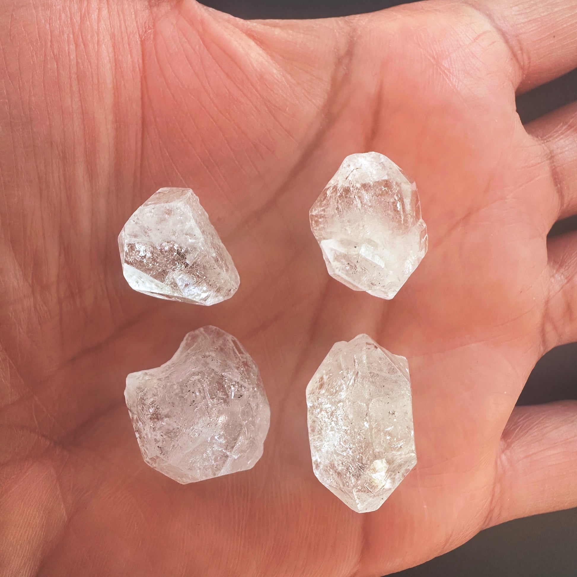 Herkimer rough gemstone with raw edges and high transparency in a 65-carat set.