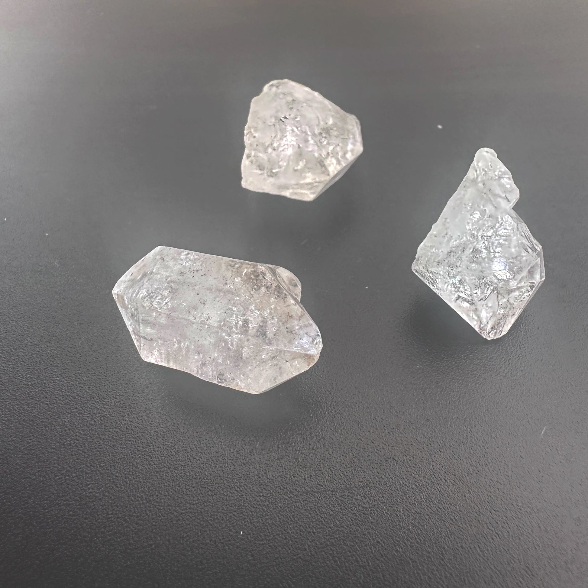 Close-up of raw Herkimer crystals showing double-terminated facets and high transparency.