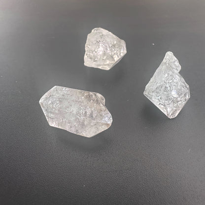 Close-up of raw Herkimer crystals showing double-terminated facets and high transparency.