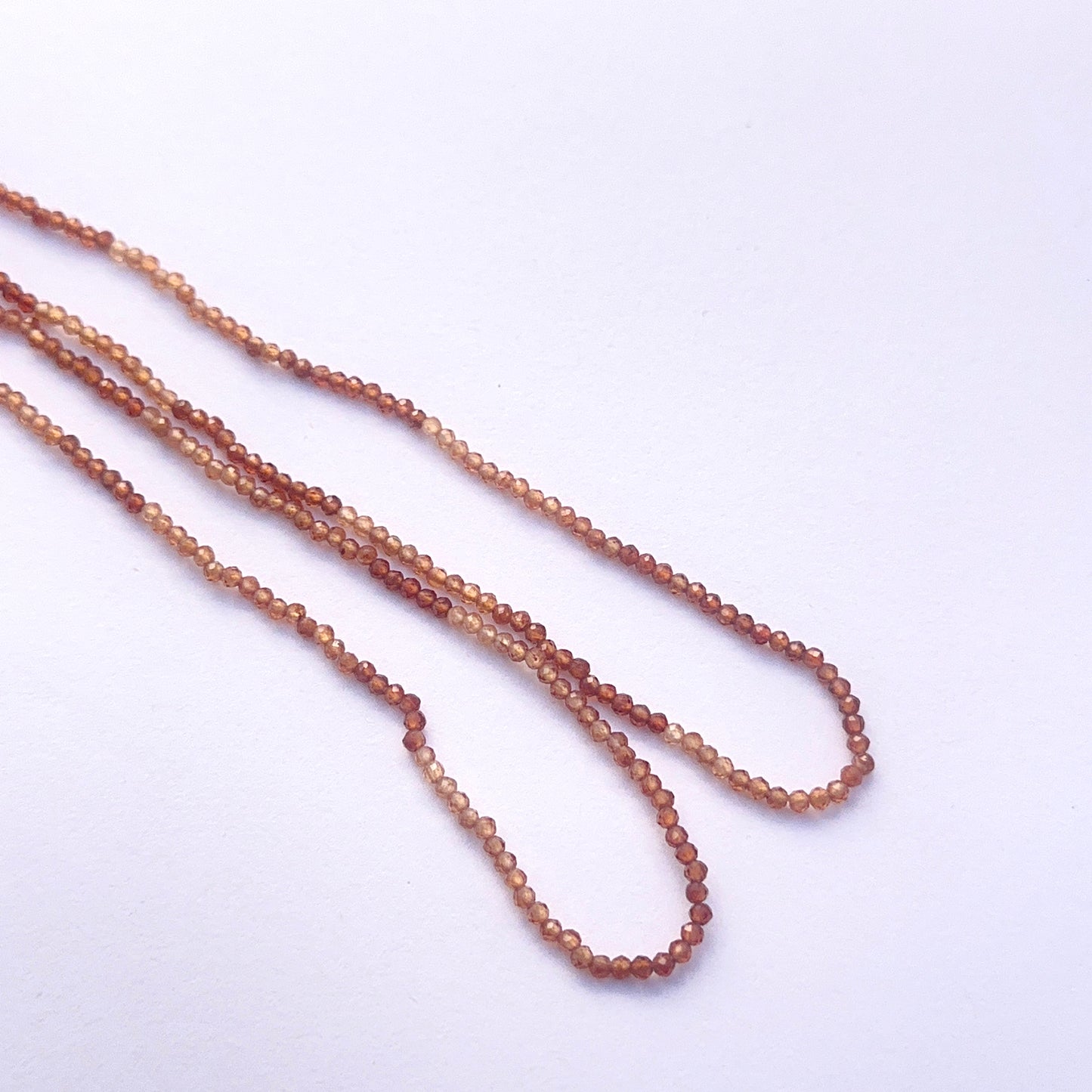Natural hessonite faceted rondelle beads with warm earthy tones for DIY jewellery.