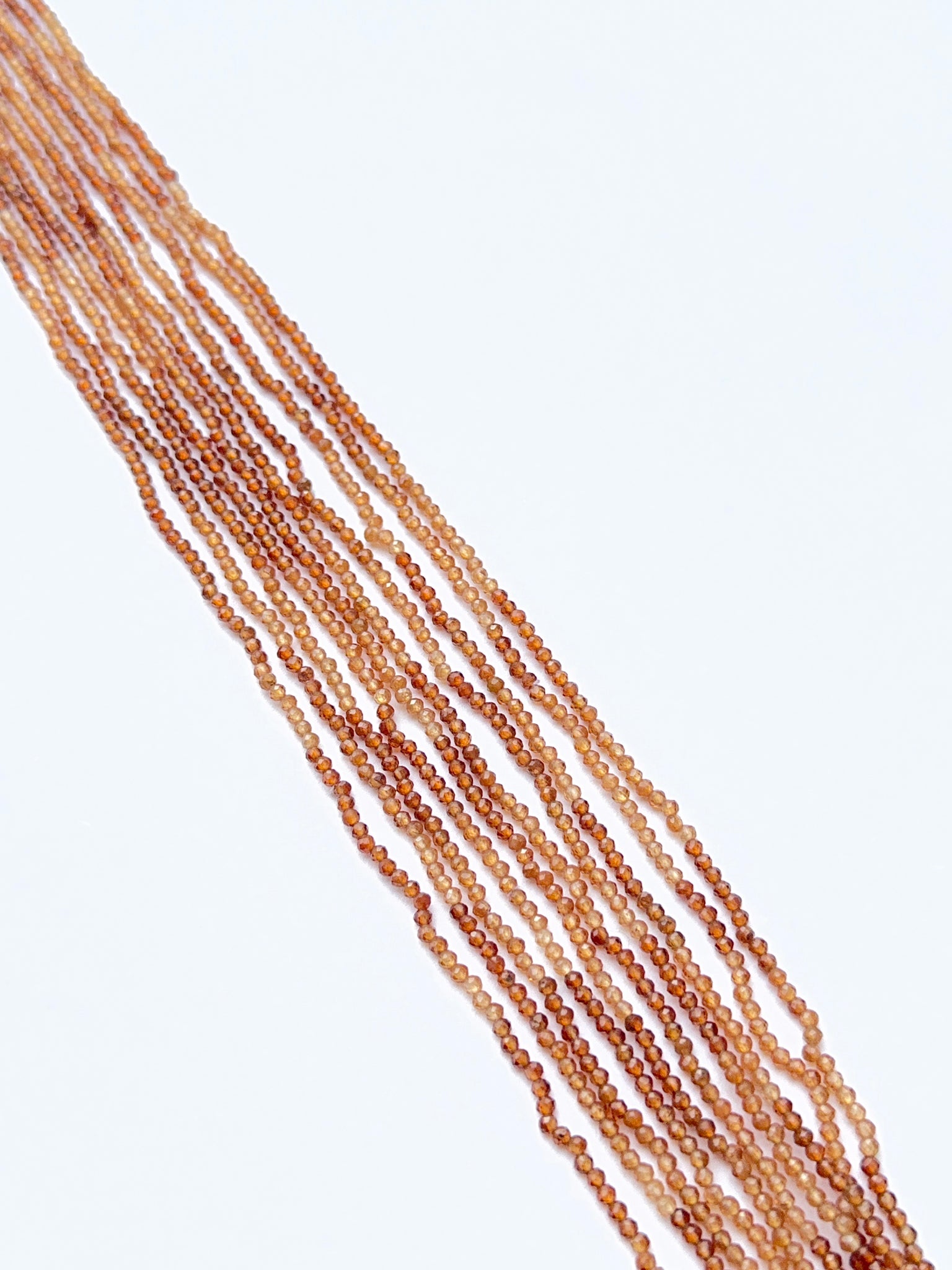 Hessonite beads photographed to show their clarity, warm glow, and natural gemstone quality.