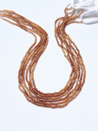 Hessonite gemstone beads arranged to showcase their rich colour and precision faceting for DIY jewellery.