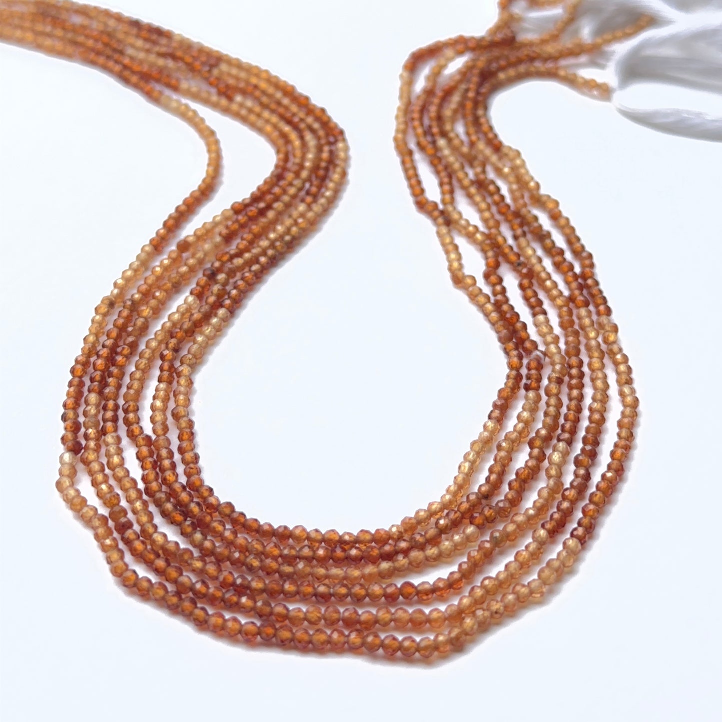 Hessonite faceted rondelle beads showing warm orange tones and fine sparkle for handmade jewellery.