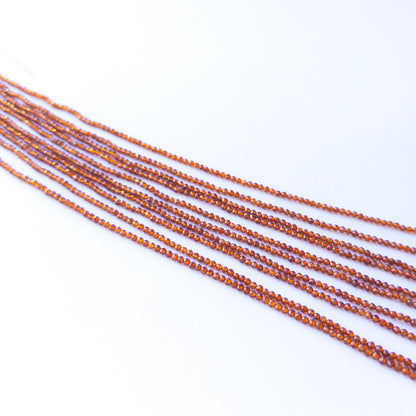Handmade jewellery components featuring natural Hessonite faceted rondelles, highlighting their colour, clarity, and bright shine.
