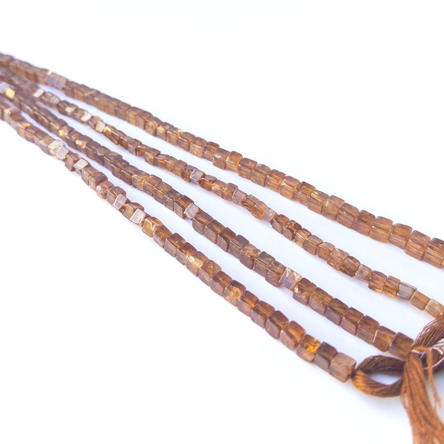 Authentic Hessonite gemstone beads showcasing rich caramel colour, smooth cube shaping and premium bead quality for jewellery designers.