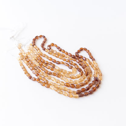 Authentic Hessonite gemstone beads displaying earthy translucency and elegant oval shaping for DIY jewellery makers.