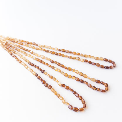 High‑quality smooth oval Hessonite beads with polished shine and uniform arrangement ideal for handcrafted jewellery.
