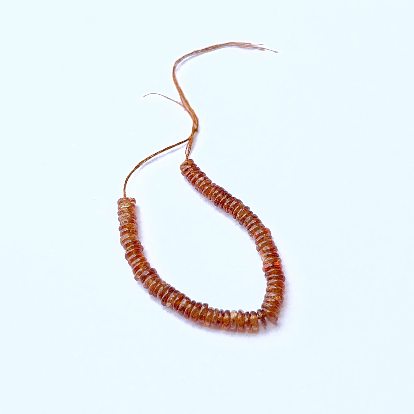 Close‑up of Hessonite stone beads in smooth wheel cut, highlighting polished finish and rich colour for handmade jewellery components.