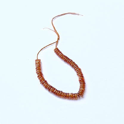 Close‑up of Hessonite stone beads in smooth wheel cut, highlighting polished finish and rich colour for handmade jewellery components.