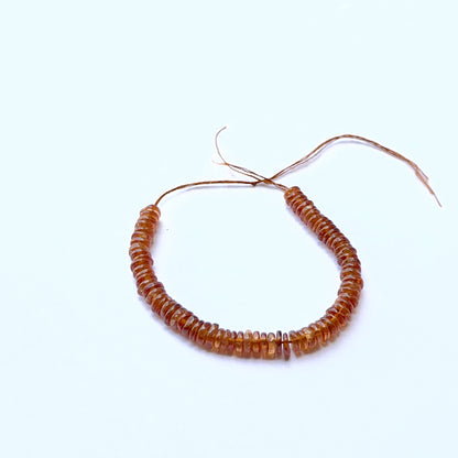 Hessonite smooth wheel natural gemstone beads in 4.5–4.7mm on a 10cm strand, showing warm honey‑brown tones for DIY jewellery.