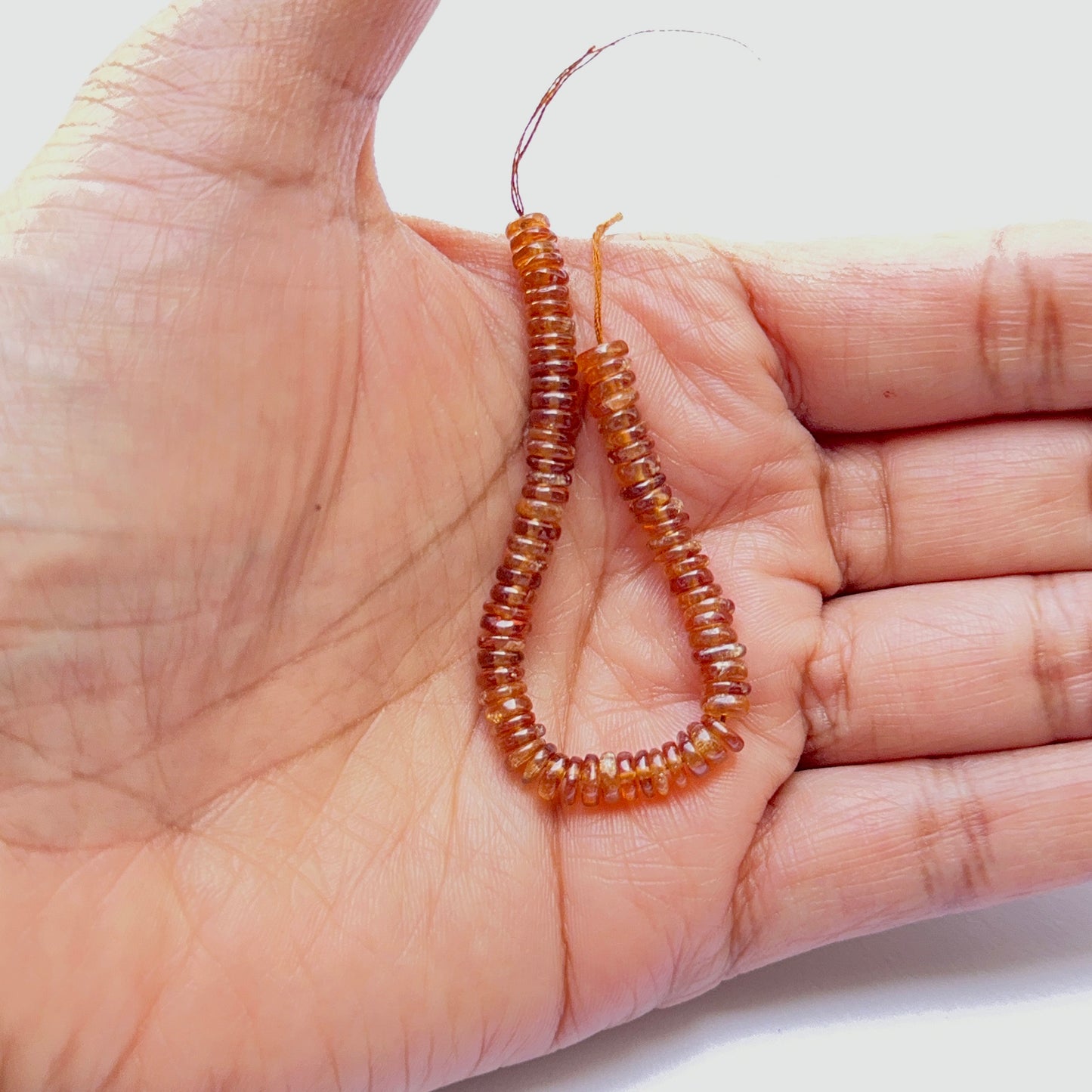 Warm‑toned Hessonite natural gemstone beads in smooth wheel shape, neatly strung for artisan jewellery making.