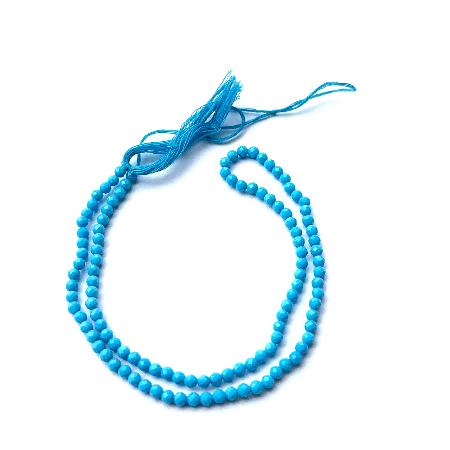 Howlite turquoise gemstone rondelles arranged neatly to showcase clarity, colour and precision faceting.