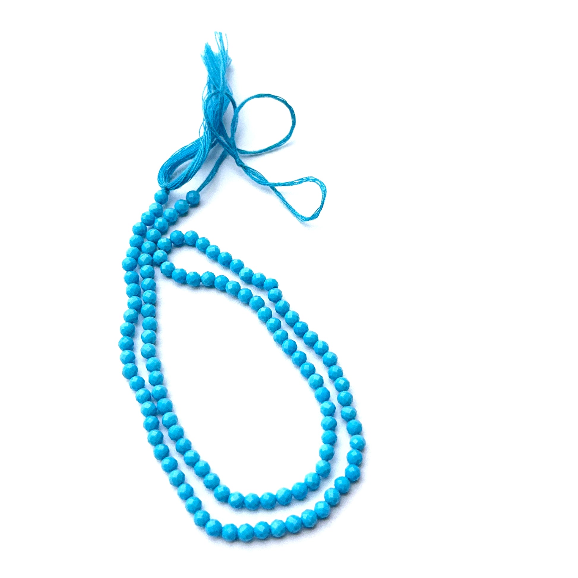 Faceted howlite turquoise beads displayed with shimmering surfaces ideal for gemstone jewellery making.