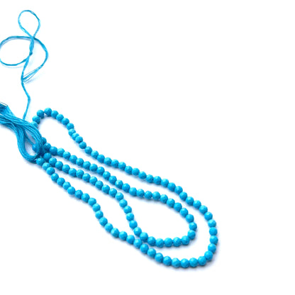 Howlite turquoise faceted rondelles photographed to show brilliance, smooth finish and gemstone quality.