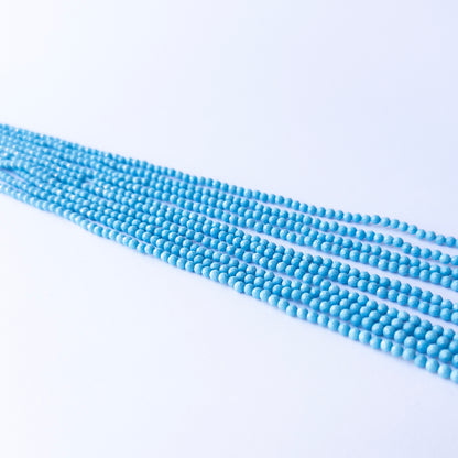 Genuine Howlite Turquoise gemstone beads in faceted rondelle cut, displaying polish, texture, and bold turquoise hues.