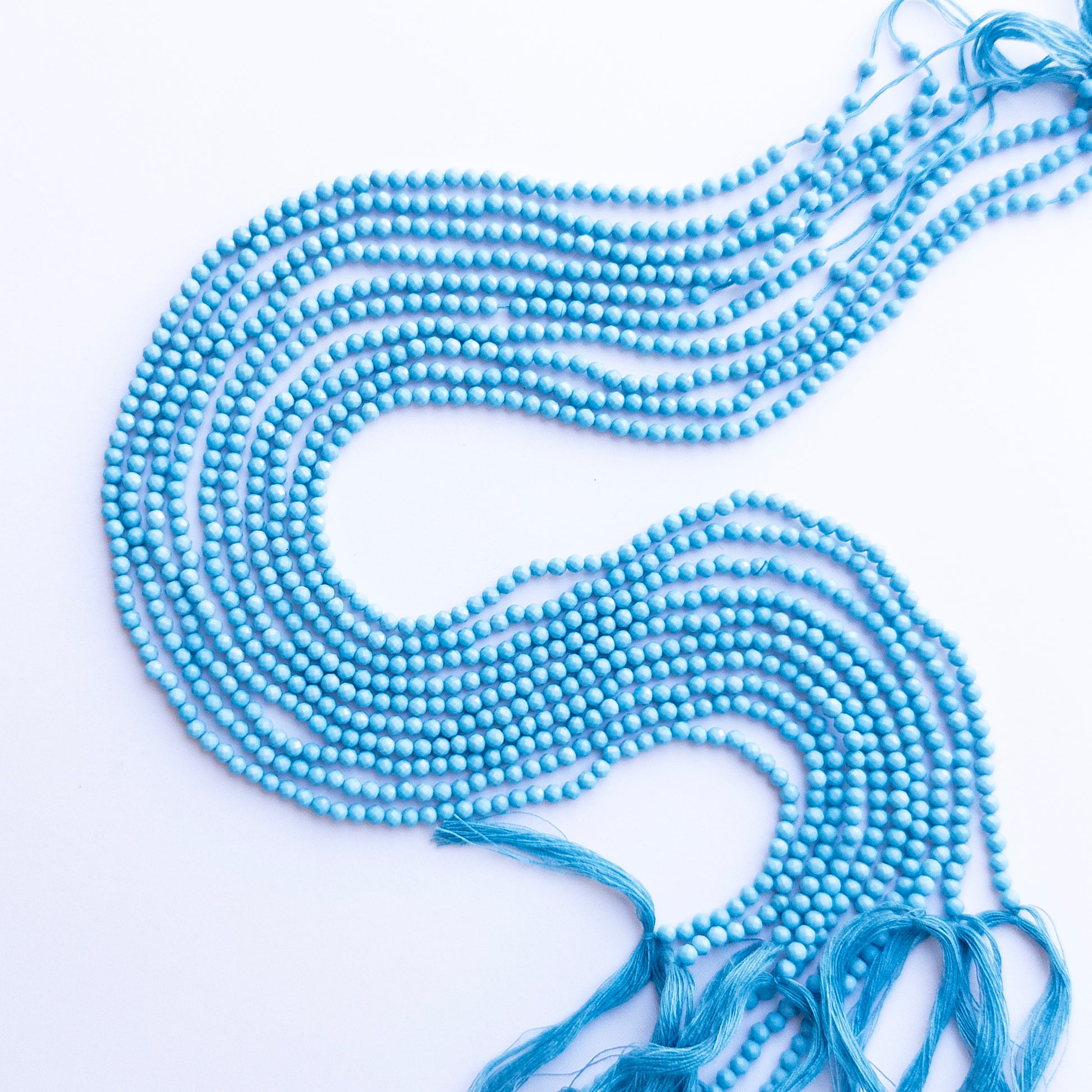 Howlite Turquoise faceted rondelle beads in 3.1mm, showing bright turquoise‑blue tones for handmade jewellery components.
