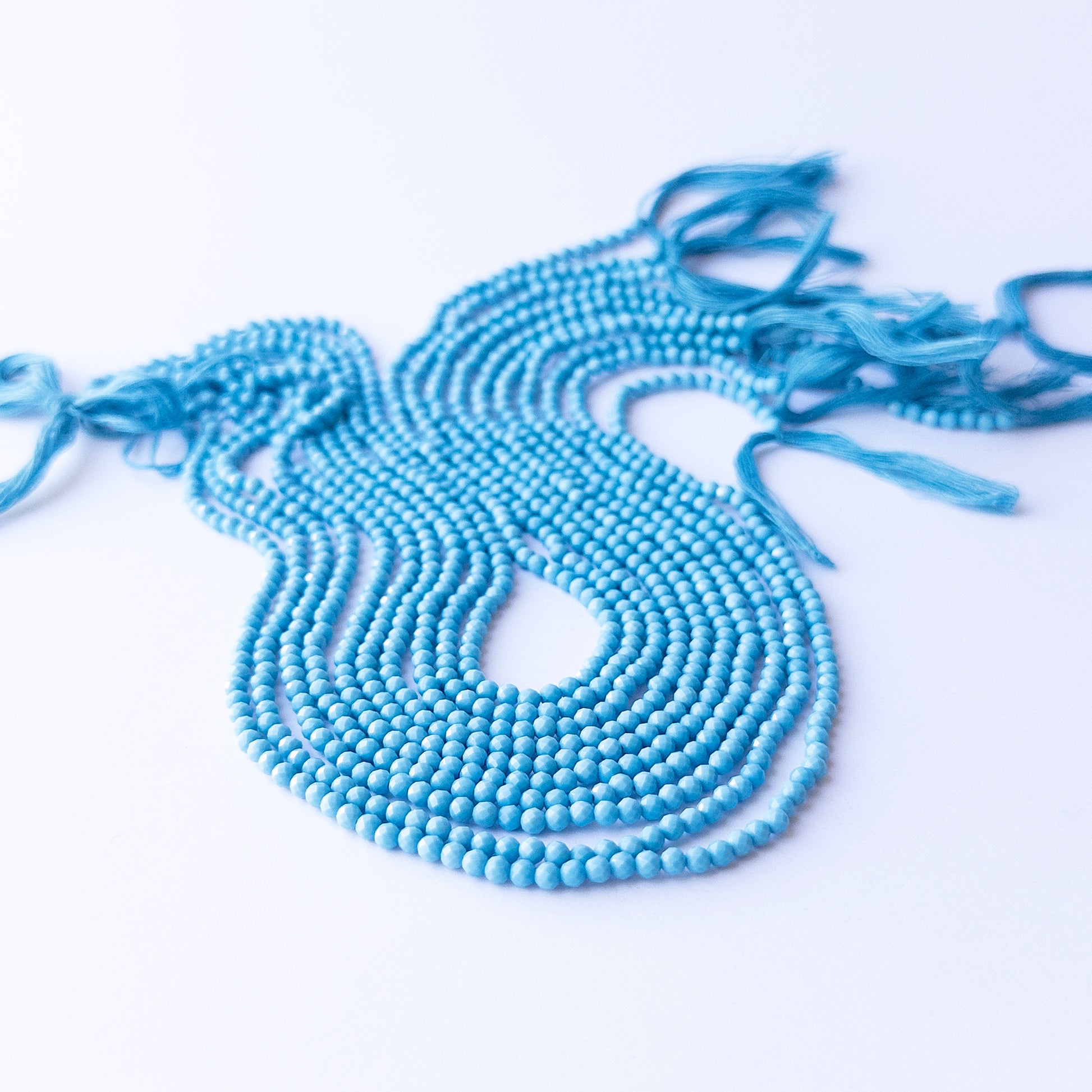 Close‑up of Howlite Turquoise faceted rondelle beads highlighting sparkle, matrix patterns, and quality for DIY jewellery making.