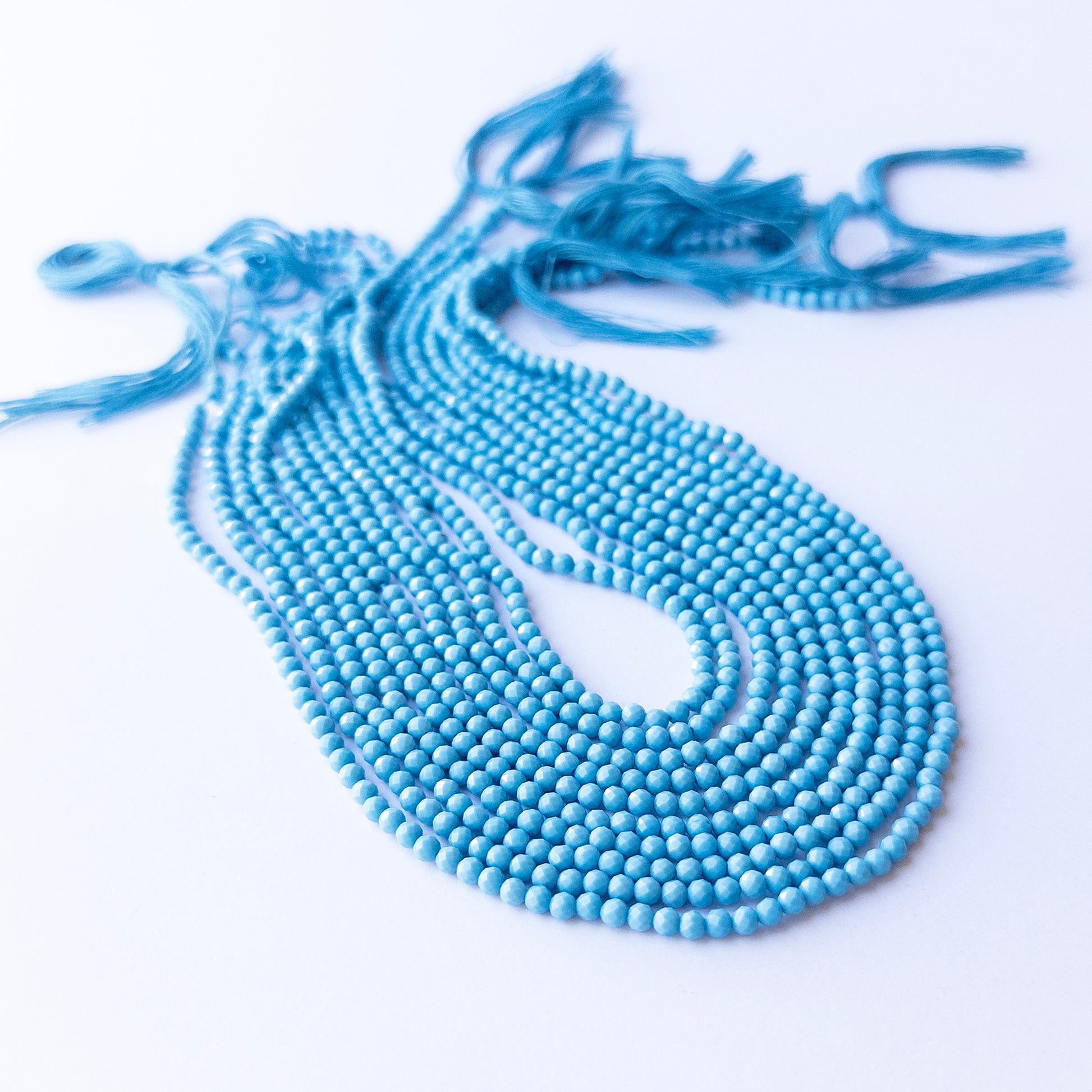 Howlite Turquoise faceted rondelle beads in 3.1mm, showing bright turquoise‑blue tones for handmade jewellery components.