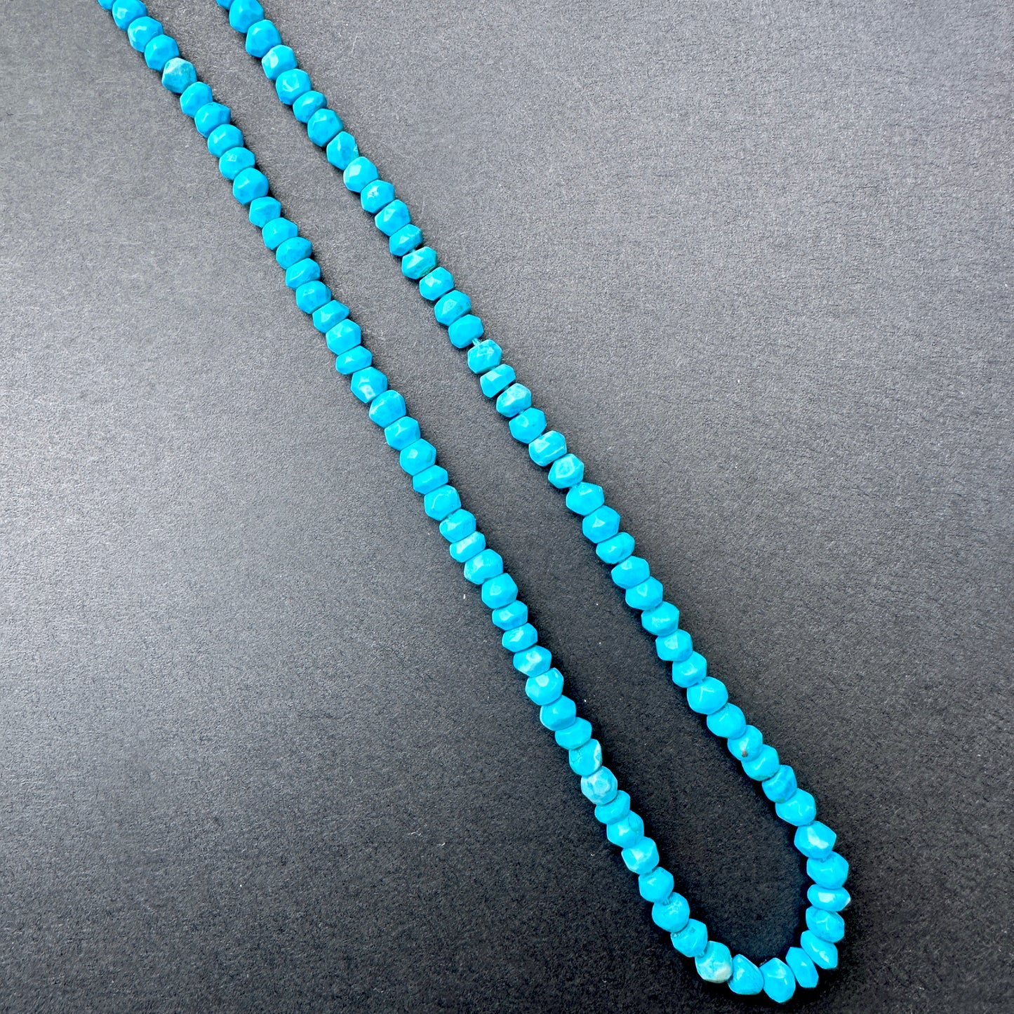 Delicate strands of Howlite Turquoise beads, showcasing their smooth design.
